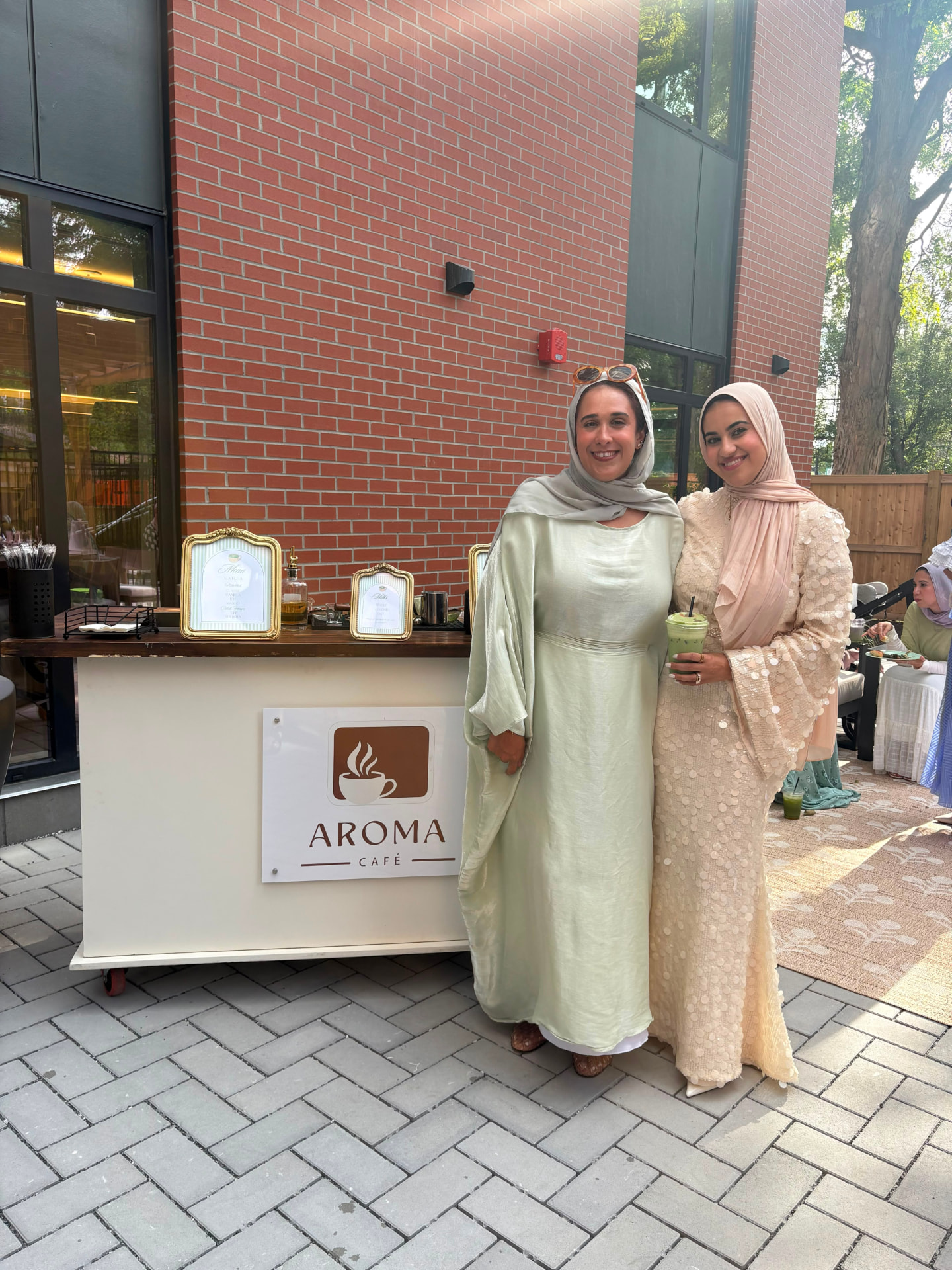 Guests with iced matcha at an Aroma Café pop-up