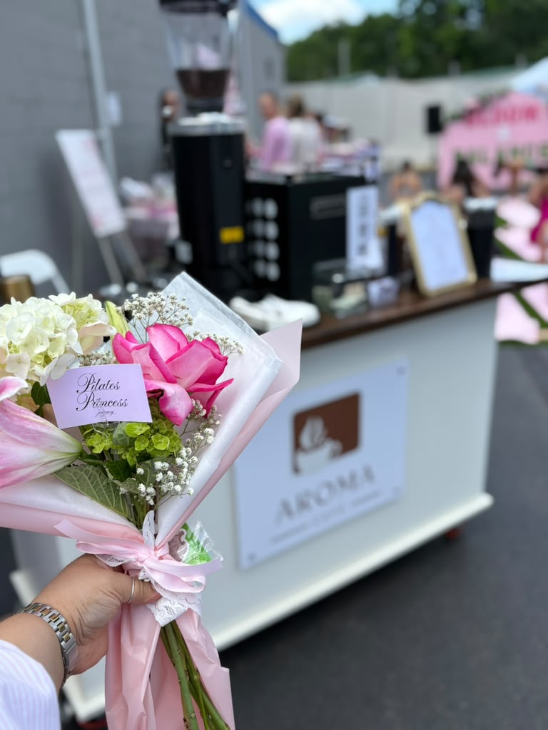 Bouquet of flowers in front of the Aroma Café cart